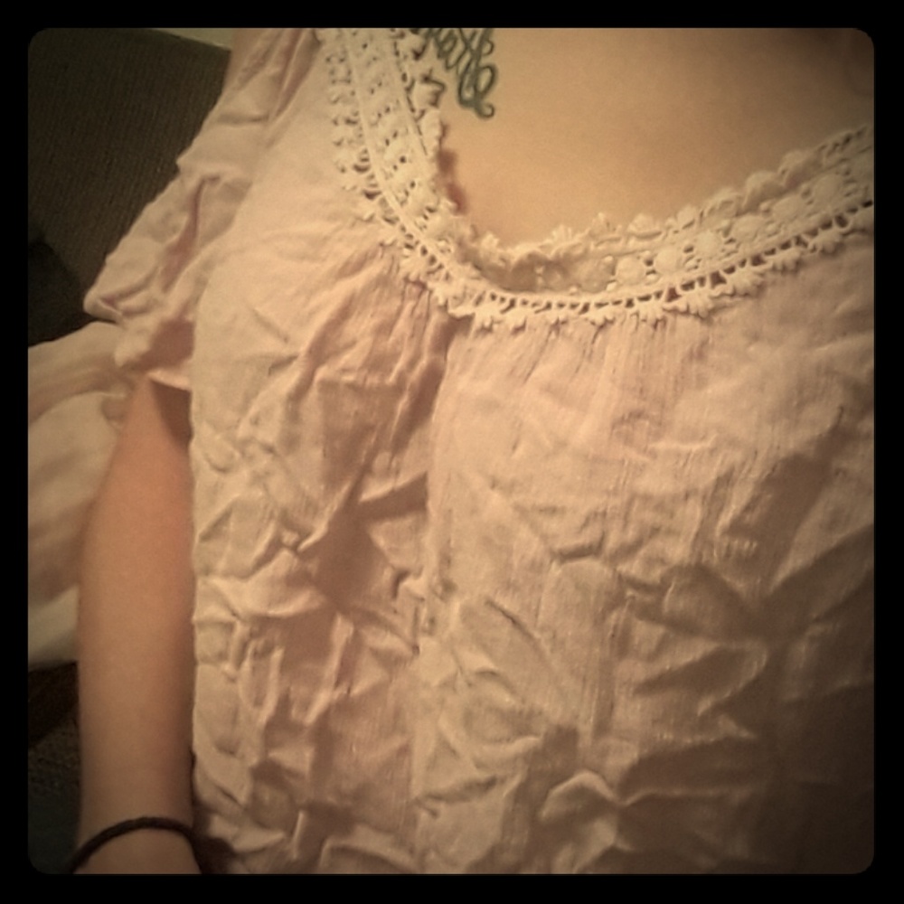 Light pink crop top that shows the shoulder